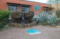 The front entrance of Say Si with a carved water feature and stamped patio with fiber optics.