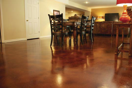 A look at a dining room with a stained concrete in reddish brown.