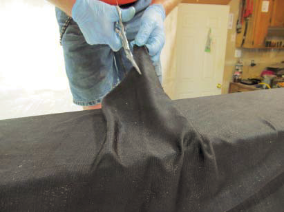 Once it was in place, we began to tug on the fabric in different areas to get our drape to the style we wanted.
