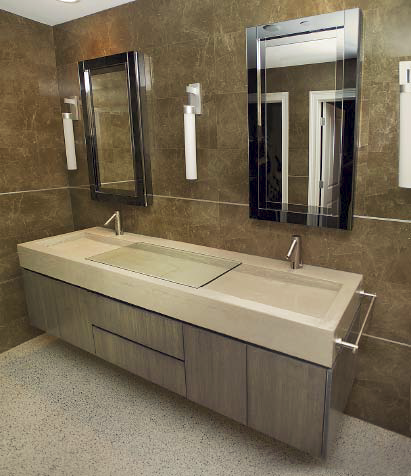 A high-end bathroom with a concrete countertop that has an invisible drain.
