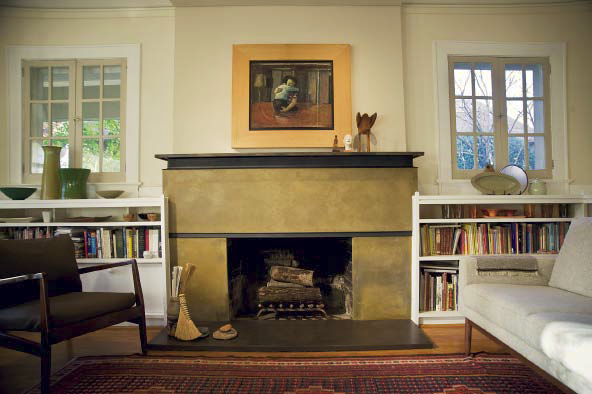 A concrete fireplace surround in a yellowish green color.