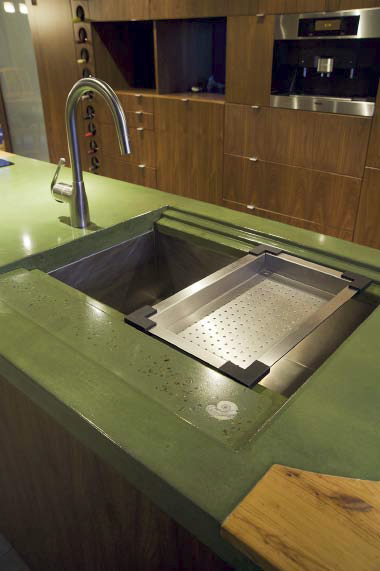 Green concrete countertop with a built in drainboard.