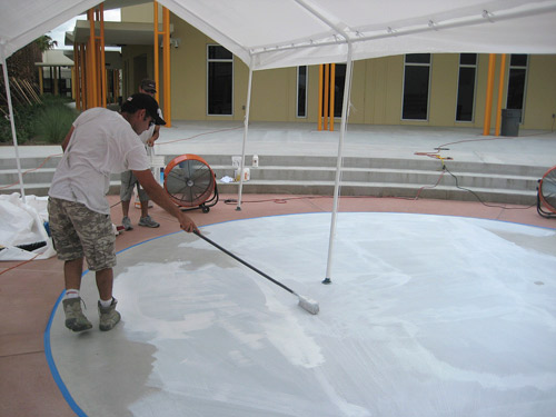 With the panel approved, he began work on the concrete in the amphitheater. The first order of business was to prepare the concrete surface to accept the stencil design.