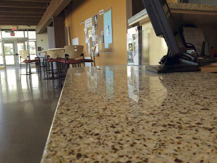 A close up of a concrete countertop in a kitchen space