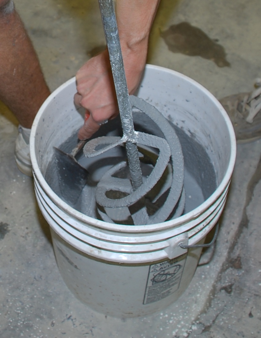 A drill mixer being used in a 5 gallon mixer