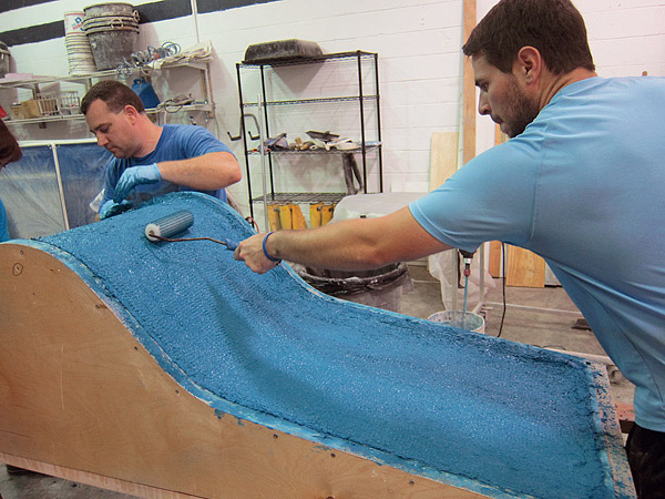 rolling thin layers of backer onto a concrete furniture mold
