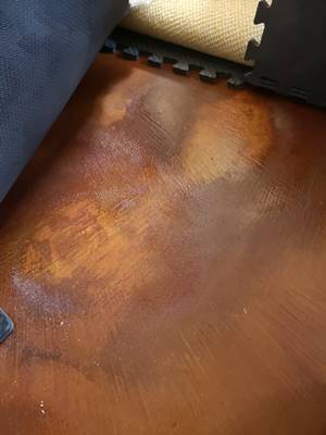 Acid stained problems after rubber mat was placed