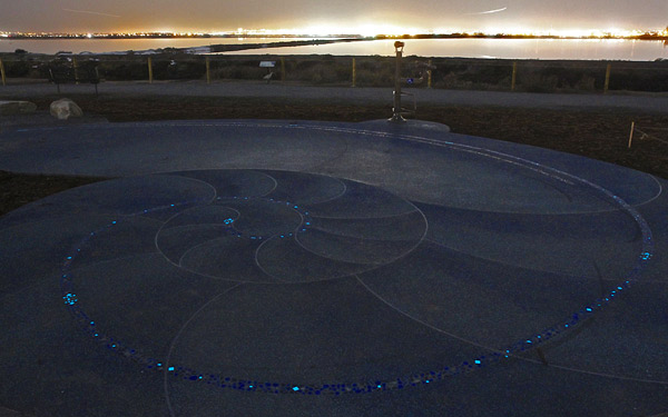 Glow-in-the-dark tiles from Vidrepur outline the spiral design for several hours into the night. Telescopes let visitors observe the migratory birds that visit the estuary.