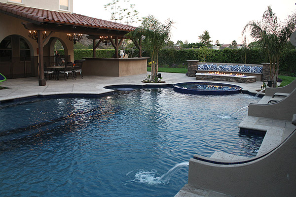 Concrete fire pit and swimming pool Photos courtesy of Green Scene Landscaping and Swimming Pools