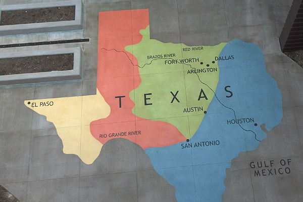 Stenciled concrete map of Texas in 1500 square foot courtyard.