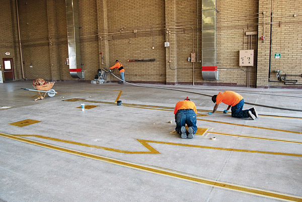 large polished concrete floor at Luke Air Force Base by Yezco Concrete Polishing outlining where the jets will park in the hangar.