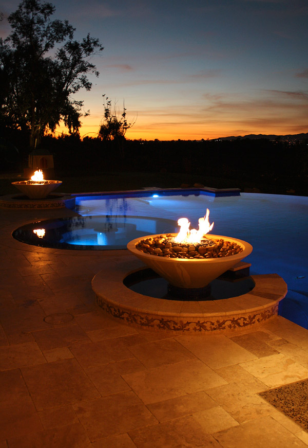 build a concrete fire pit like seen here next to an infinity pool at dusk