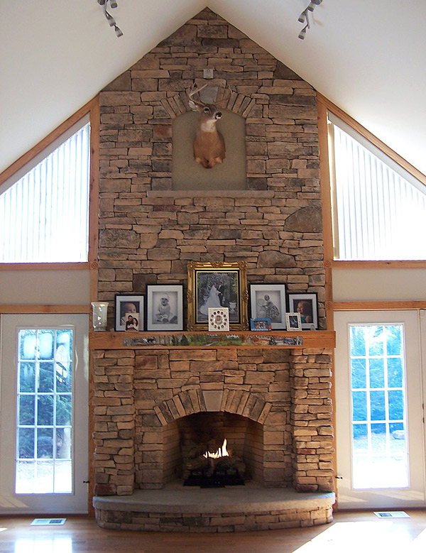 Vertical carved stone fireplace