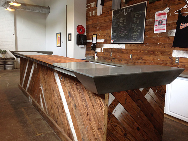 The Luke Works crew, along with the brewery owners' family and friends, had a cast party to batch and cast the four concrete sections for Union Craft's tasting room's bartop. The center section is made from reclaimed oak, steel and copper.
