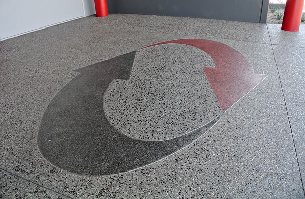 integrally colored and glass seeded concrete - The Switch SuperNAP data center includes decorative concrete areas that are integrally colored and glass-seeded. Seen above is the companys logo outlined with stainless-steel inserts. At left is a detail from an adjacent part of the project. Photos courtesy of Chief Concrete