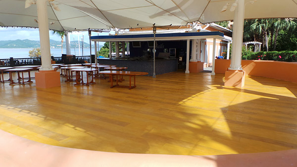 Sundek concrete floor - A large awning partially covered the resorts outdoor restaurant and lounge. Island storms would blow rainwater into the restaurant, which would collect in low spots on the concrete floor.