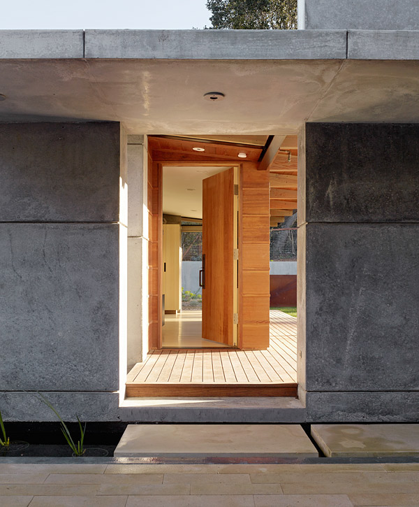 Cross a moat and youll enter the concrete portal to House 7s guest house. The flanking wall and canopy are extensions of the main house wall and upper deck. The 450-square-foot guest house in Los Altos Hills, California, has its own deck, bathroom and living space. Photo by Matthew Millman Photography