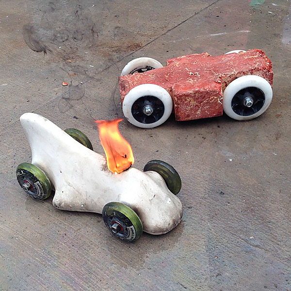 Grand prize winner Peter Cicalos car (left, aflame) was made entirely of concrete. Buddy Rhodes entry (right) won the most heats. Photo by Jeremy French