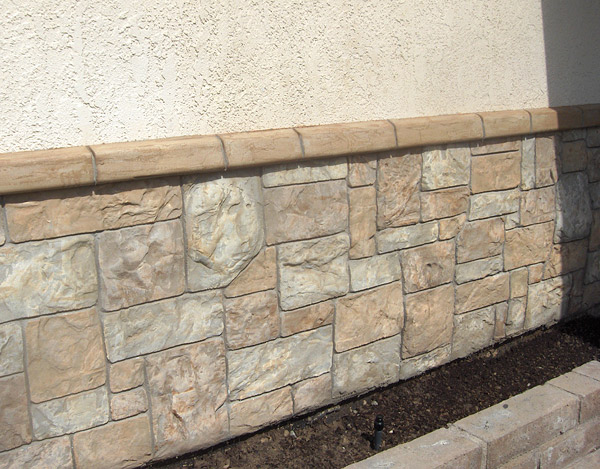 Cultured Stone That Looks Like Ashlar Slate - Flex-C-Ment Wall Mix was applied and stamped with Wall texture skin molds, then hand-carved into an ashlar slate-like vertical pattern. Accent Enhancer and water-based acrylics were then used to color the wall before it was sealed. Photo courtesy of Flex-C-Ment