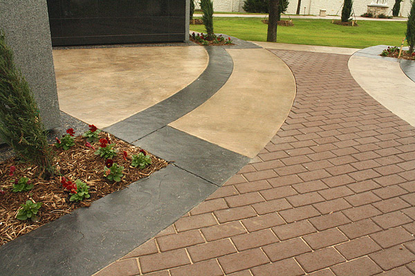 Architect Scott Martsolf with Martsolf Architecture in Fort Worth specified stamped concrete with both integral color and color hardener as the prominent concrete feature for both the walkway and the bases of the four columbarium clusters. The circular bases feature a hub-and-spoke design