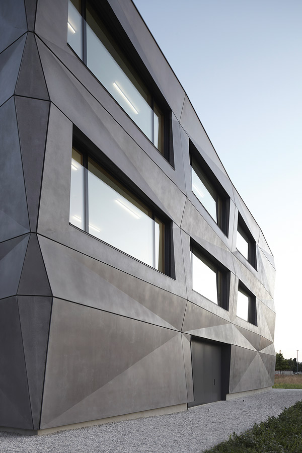 Concrete facade on Munich Textilmacher mimics folded fabric.