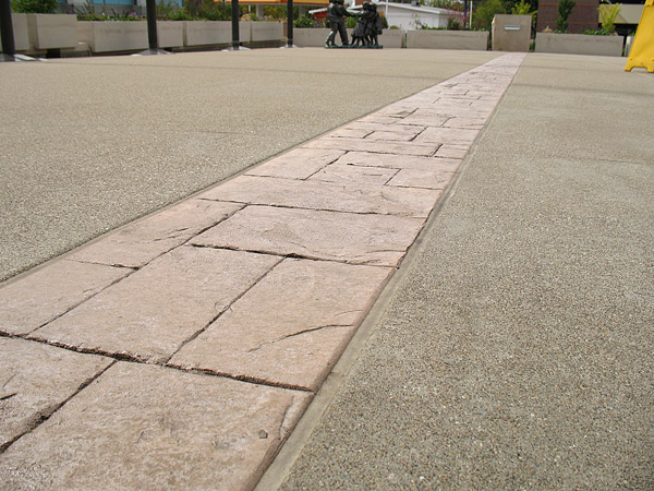 Awesome ribbon of stamped concrete sections off exposed aggregate