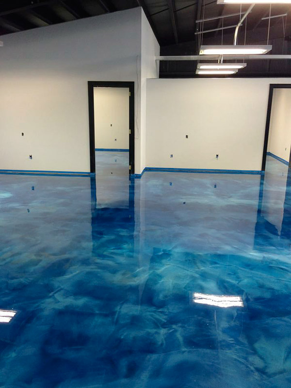 blue swirly concrete floor in a converted warehouse to a glamorous office space.