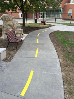 concrete racetrack sidewalk with stamping applications