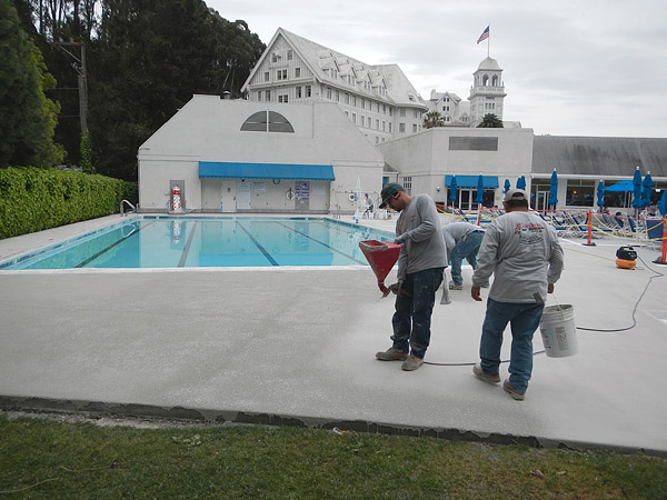 pool deck with workers applying and overlay