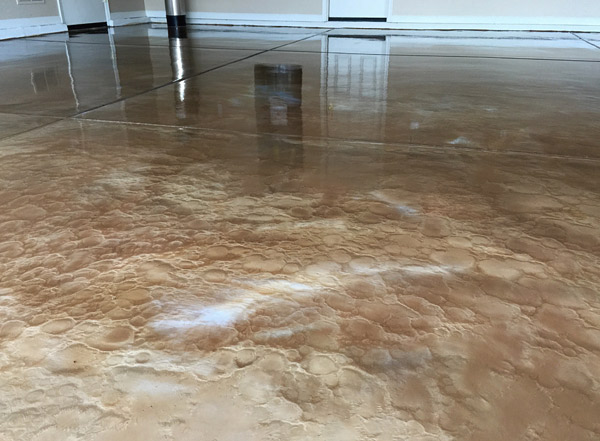 copper metallic epoxy concrete floor - Solvents can help give a metallic floor a swirling movement and also create craters that provide a three-dimensional look. 