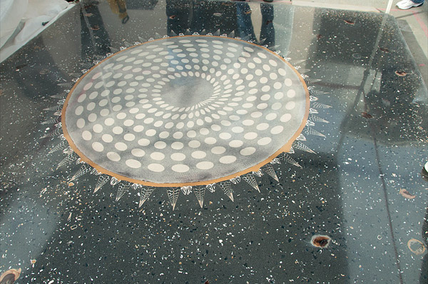 circle with bubble details in a swirl on dark concrete floor