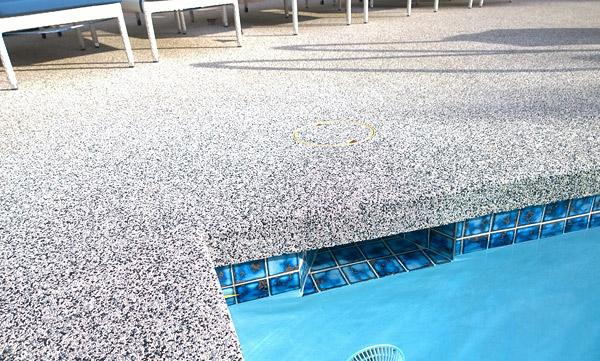 speckled concrete pool deck area