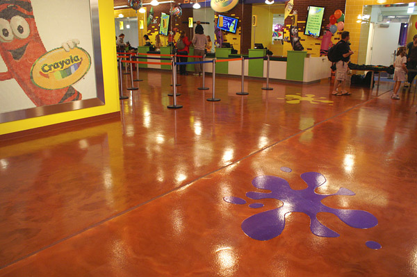 A metallic epoxy coating produced the rich, deep tone of this floor treatment. A polyaspartic with a fine, nonskid additive was used as the floors topcoat. It was also used to create the splashes of color. 
