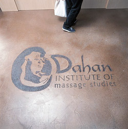 institute of massage studies logo on brown floor