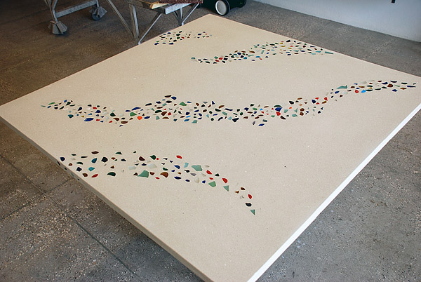 Create a concrete table in 4 days with embedded glass pieces.