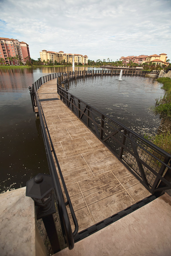 stamped concrete walkway bridge over water