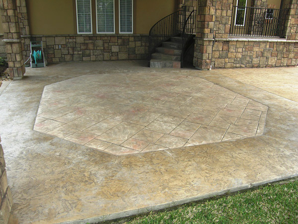 six sided stamped concrete shape set into a large textured concrete patio