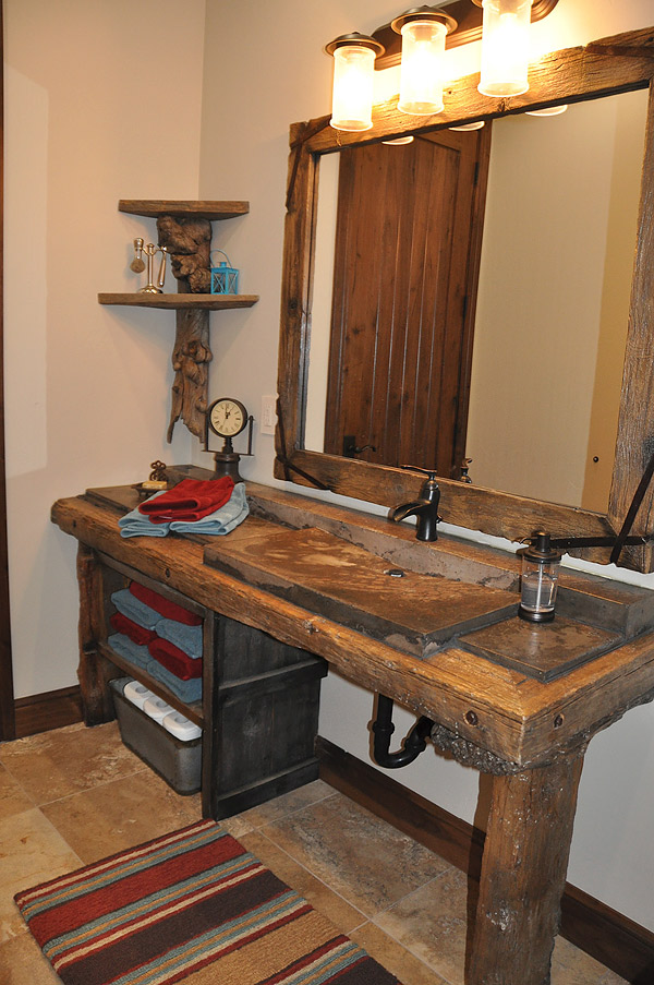 Bathroom vanity with a concrete sink and a slab of wood that is actually concrete as the countertop.
