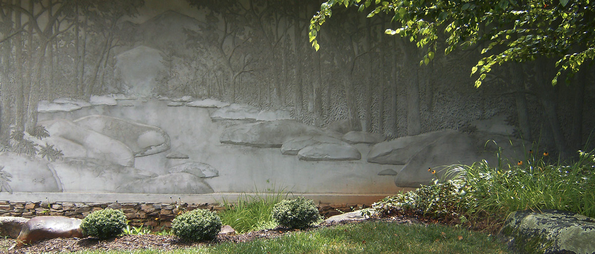 embedded concrete wall with trees and lake