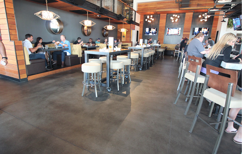 dark brown floor in restaurant is another example of how concrete shines in San Diego