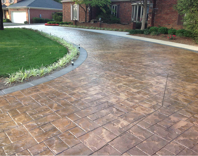 stamped concrete driveway with grass around