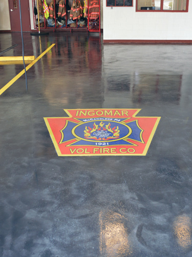 embedded fire company logo on grey and white floor