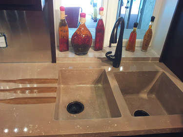 two sink concrete countertop with a wine bottle shaped drain area
