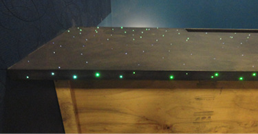 Concrete table top with green LED lights dotted throughout