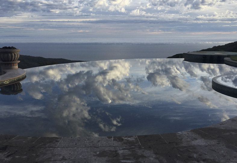 reflection of sky and clouds on swimming pool