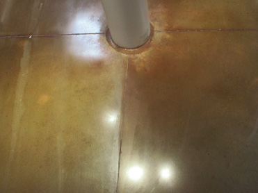 brown concrete floor with rust and residue