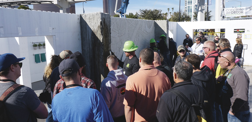 joshua annis carving concrete fireplace with crowd at world of concretesurrounds