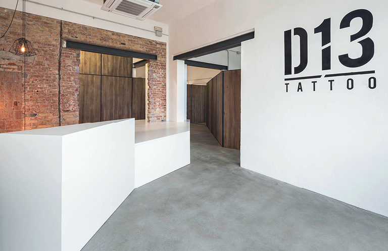 Tattoo parlor uses concrete as it's countertop material. White countertop in D13 Tattoo.