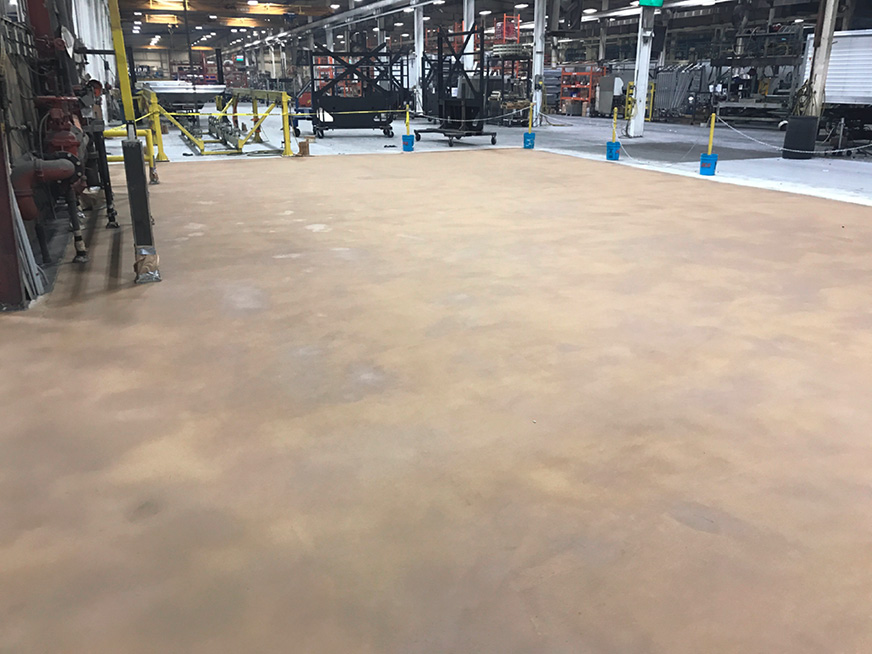 timpte manufacturing plant had ground-in dirt and oils that added to the toxic mix that needed to be repaired with decorative concrete overlay.