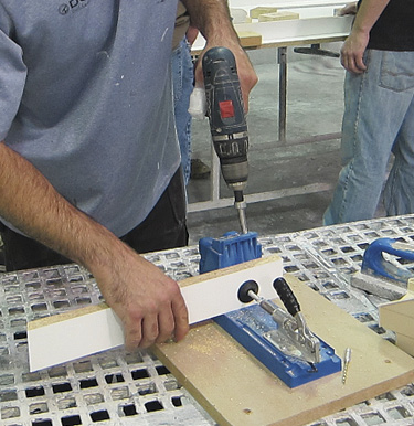To use the pocket-hole technique, you first use a jig to drill the pocket-screw hole, as shown in this photo: